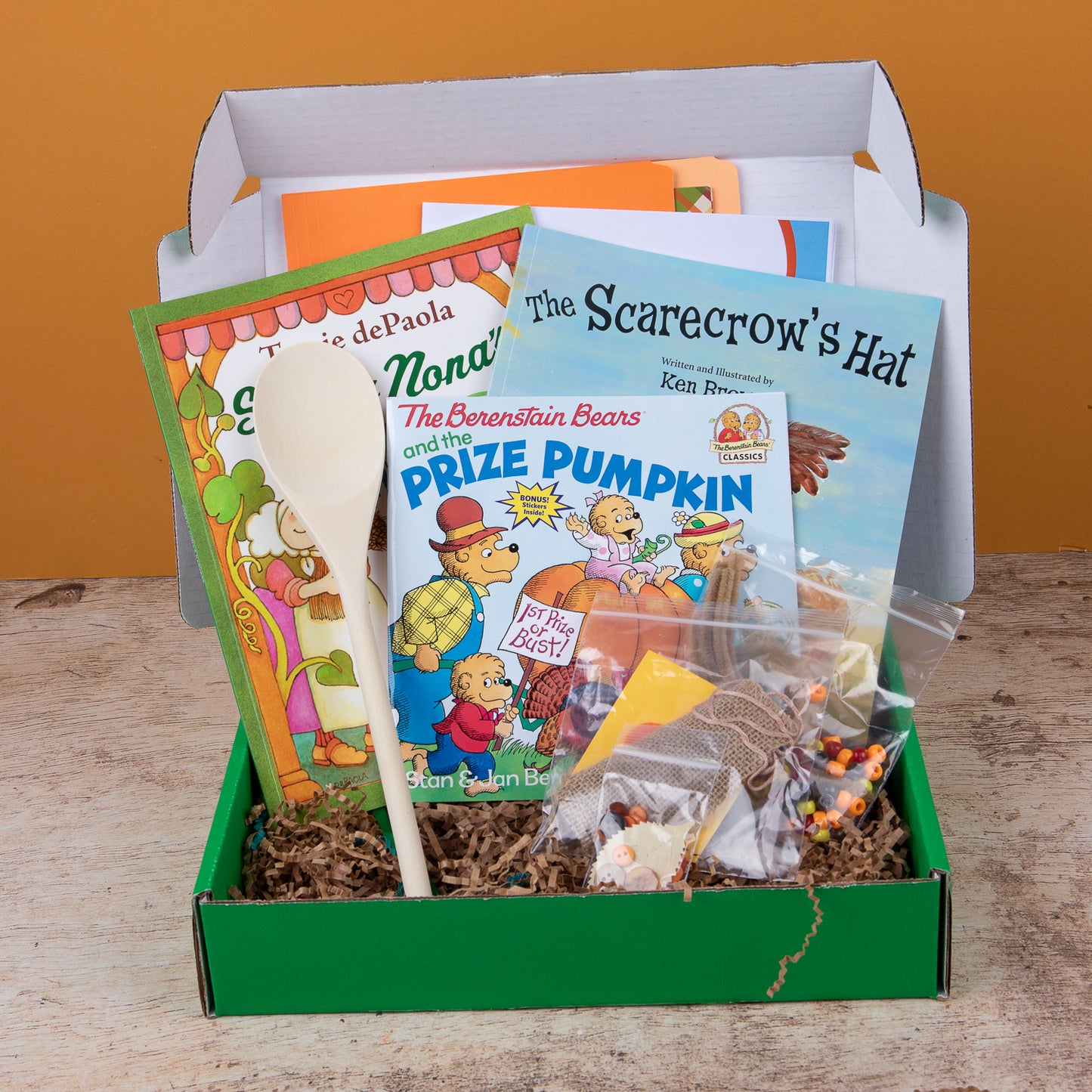 Fall themed book subscription box for kids ages 5-7 that includes a variety of themed books, and materials for crafts and activities related to the theme.
