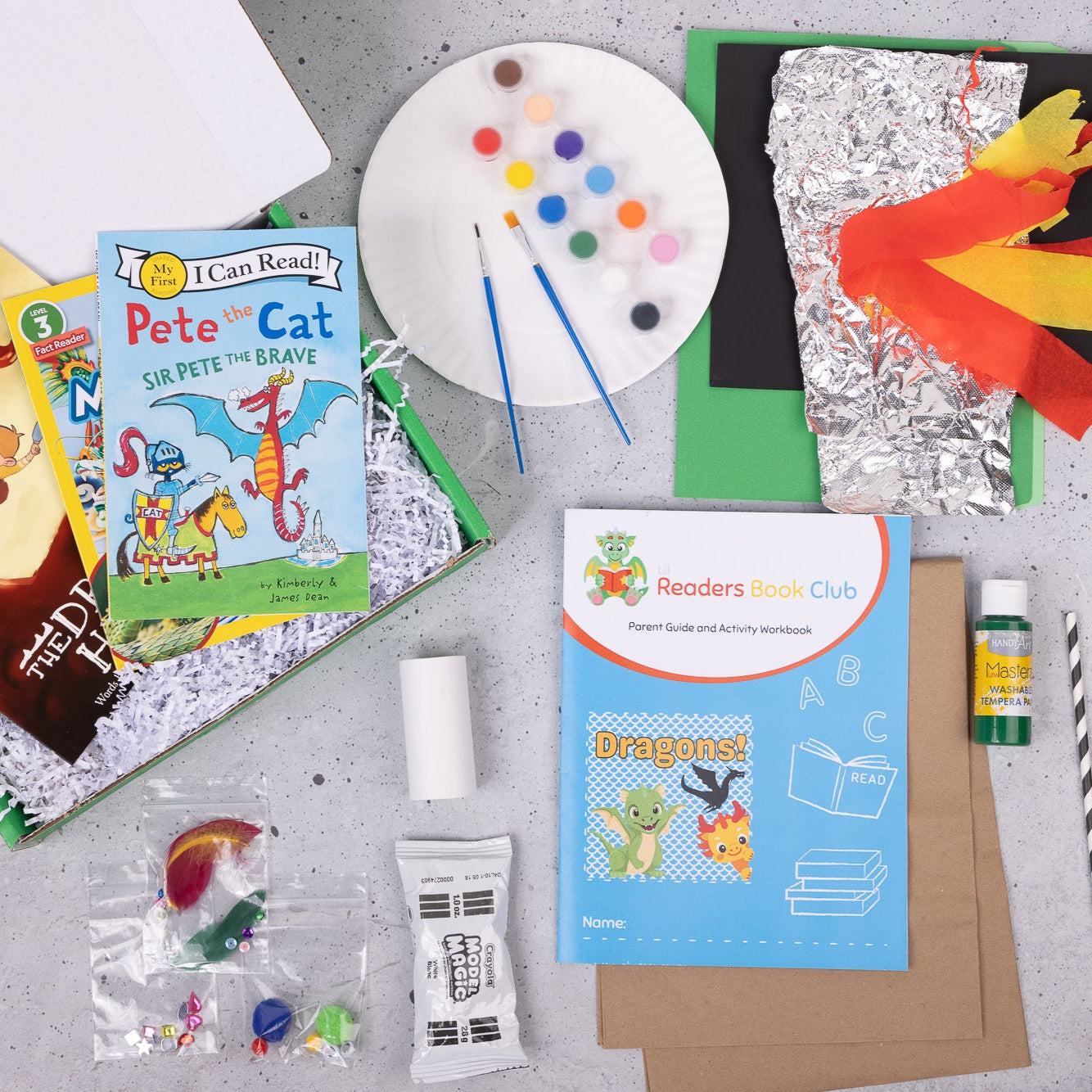 Books and crafts from the Dragon themed Lil Readers book club box, a book subscription for kids aged 5-7